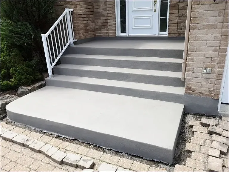 Rebuilt entrance steps with a clean grey finish